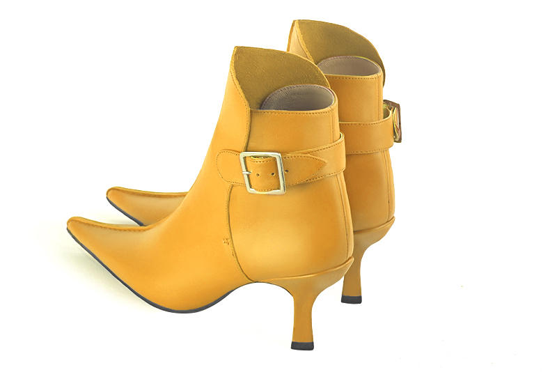 Mustard yellow women's ankle boots with buckles at the back. Pointed toe. High spool heels. Rear view - Florence KOOIJMAN